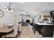 Open-concept living space with vaulted ceilings, modern furniture, and seamless flow between kitchen and living areas at 209 Roman Ct, Deltona, FL 32738