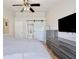 Main bedroom with a barn door entrance, large window, dresser, and modern finishes at 209 Roman Ct, Deltona, FL 32738