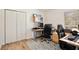 Bright office featuring wood floors, a large closet, and a desk setup, creating a functional workspace at 209 Roman Ct, Deltona, FL 32738