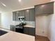 Modern kitchen features stainless steel appliances, gray cabinets, and white quartz countertops at 2296 Sirena Ln, Mount Dora, FL 32757