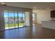 Open-concept living room features tile floors, lots of light and a sliding glass door to the backyard at 2296 Sirena Ln, Mount Dora, FL 32757