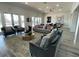 Bright living room features modern decor, comfortable seating, and wood-look tile flooring at 2296 Sirena Ln, Mount Dora, FL 32757