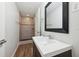 Modern bathroom with updated vanity, framed mirror, and newly tiled shower at 2318 Vincent Rd, Orlando, FL 32817