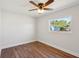 Bedroom featuring wood-look floors, a ceiling fan, and a window with views of the outdoors at 2318 Vincent Rd, Orlando, FL 32817