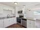 Newly renovated kitchen with stainless steel appliances, granite countertops, and white cabinetry at 2318 Vincent Rd, Orlando, FL 32817