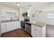 Modern kitchen with stainless steel appliances, granite counters, white cabinets, and modern fixtures at 2318 Vincent Rd, Orlando, FL 32817