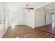 Open-concept living room with hardwood floors, ceiling fan, and easy access to the kitchen at 2318 Vincent Rd, Orlando, FL 32817