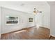 Bright living room featuring hardwood floors, a ceiling fan, and plenty of natural light from the windows at 2318 Vincent Rd, Orlando, FL 32817