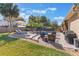 Private backyard with pool, sun loungers, patio seating, and lush landscaping, ideal for relaxation at 2361 Baker Ave, Orlando, FL 32833