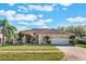 Charming single-story home features a well-manicured lawn, mature trees and a two car garage at 2361 Baker Ave, Orlando, FL 32833