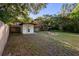 Backyard featuring a fire pit near a shed with fencing around perimeter at 241 S Marydell Ave, Deland, FL 32720