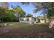 Fenced backyard featuring a fire pit, green grass and a shed at 241 S Marydell Ave, Deland, FL 32720