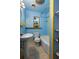 Small blue bathroom featuring a sink, toilet, tub/shower, with tiled floors, and a window at 241 S Marydell Ave, Deland, FL 32720