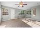 Bright, carpeted bedroom with multiple windows and natural light; ceiling fan included at 241 S Marydell Ave, Deland, FL 32720
