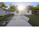 Charming single-story home featuring a cozy front porch and a spacious concrete driveway at 241 S Marydell Ave, Deland, FL 32720