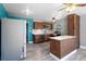 Kitchen with wood cabinets, stainless appliances, and adjacent dining area with an accent wall at 241 S Marydell Ave, Deland, FL 32720