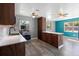 Updated kitchen with stainless steel appliances, wood cabinets, and a pass-through island at 241 S Marydell Ave, Deland, FL 32720