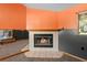 Living room featuring a cozy fireplace with decorative tile and wall at 241 S Marydell Ave, Deland, FL 32720