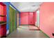Small room with green and pink walls, an exterior door, and flooring combination at 241 S Marydell Ave, Deland, FL 32720