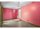Small room with pink walls, exterior door, and mixed flooring at 241 S Marydell Ave, Deland, FL 32720
