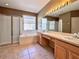 Bathroom featuring double vanity, shower, soaking tub, and tile flooring at 2519 Cypress Trace Cir, Orlando, FL 32825