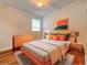 Bright bedroom features an orange bed frame with gray walls and hardwood floors at 2519 Cypress Trace Cir, Orlando, FL 32825