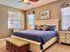 Cozy bedroom featuring a large bed, two windows, and neutral paint at 2519 Cypress Trace Cir, Orlando, FL 32825