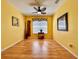 Sunny bedroom with hardwood floors, decorative accents, a ceiling fan, and large window offering ample natural light at 2519 Cypress Trace Cir, Orlando, FL 32825