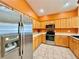 Bright kitchen featuring stainless steel appliances, tile floors, and ample counter space at 2519 Cypress Trace Cir, Orlando, FL 32825