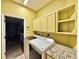 Convenient laundry room features built-in cabinets and counter space next to the garage entrance at 2519 Cypress Trace Cir, Orlando, FL 32825