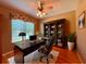 A cozy home office with a sleek black desk, leather chair, and built-in bookcase at 2519 Cypress Trace Cir, Orlando, FL 32825