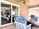 Covered patio with comfortable seating, ceiling fan, grill, and sliding glass doors at 2519 Cypress Trace Cir, Orlando, FL 32825