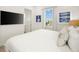 Charming bedroom with king bed, nautical decor, and a television on the wall at 2967 Latitude Ln, Kissimmee, FL 34747