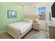 Charming bedroom featuring a twin bed with a nightstand and an accent wall at 2967 Latitude Ln, Kissimmee, FL 34747