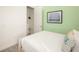 Bedroom with light green accent wall and closet at 2967 Latitude Ln, Kissimmee, FL 34747
