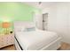 Bright bedroom with a king bed, green accent wall, and a closet for easy storage at 2967 Latitude Ln, Kissimmee, FL 34747