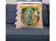 Close-up of a decorative throw pillow with a Margaritaville Island Life design at 2967 Latitude Ln, Kissimmee, FL 34747