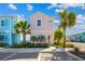 Charming pastel-colored two-story home with tropical landscaping and palm trees in a vibrant community at 2967 Latitude Ln, Kissimmee, FL 34747