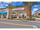 Exterior of Flower Cafe, a charming bakery and coffee shop with a brick facade and inviting outdoor seating at 2967 Latitude Ln, Kissimmee, FL 34747