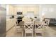 Bright kitchen and dining area featuring stainless steel appliances, countertops, and a large dining table at 2967 Latitude Ln, Kissimmee, FL 34747