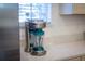 Elegant kitchen with modern ice-making blender on marble countertop and white cabinets at 2967 Latitude Ln, Kissimmee, FL 34747