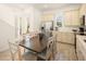 Spacious kitchen and dining area with stainless steel appliances and a large wooden dining table at 2967 Latitude Ln, Kissimmee, FL 34747