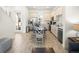 Modern kitchen and dining area with stainless steel appliances, white cabinets, and a large dining table at 2967 Latitude Ln, Kissimmee, FL 34747