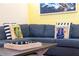 Cozy living room with a comfortable blue couch and decorative Margaritaville-themed pillows at 2967 Latitude Ln, Kissimmee, FL 34747