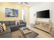 Inviting living room with a cozy sectional sofa, entertainment center, and bright, cheerful decor at 2967 Latitude Ln, Kissimmee, FL 34747