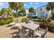 Relaxing patio featuring comfortable lounge chairs and a dining table, ideal for enjoying the outdoors at 2967 Latitude Ln, Kissimmee, FL 34747