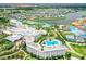 Aerial view of lakefront community with a hotel, resort, landscaping, pools, parking, and townhomes at 3083 Pirate Way, Kissimmee, FL 34747