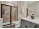 Well-lit bathroom featuring a glass-enclosed shower, modern vanity, and a stylish mirror at 3083 Pirate Way, Kissimmee, FL 34747