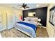 Relaxing bedroom features wood-look flooring, ceiling fan and storage at 3083 Pirate Way, Kissimmee, FL 34747