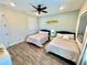 Spacious shared bedroom with two beds, ceiling fan and closet at 3083 Pirate Way, Kissimmee, FL 34747